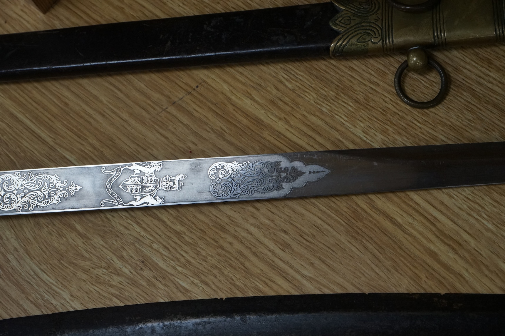 A post 1902 Naval Officer’s Dirk, the regulation blade with crowned fouled anchor, regulation hilt with remains of bullion dress knot in its leather scabbard with brass mounts, locket engraved with owners initials; RSA